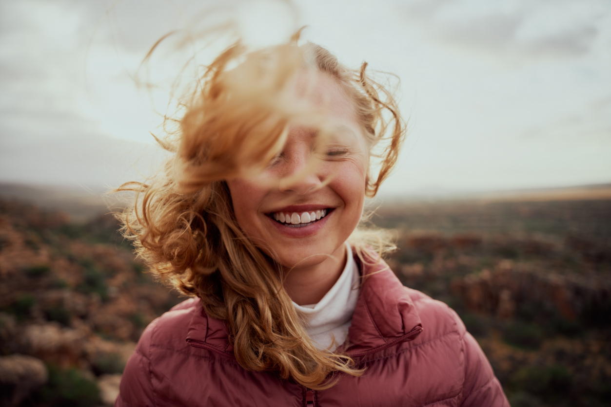 A smiling woman outdoors — feeling well again with the Edinburgh Centre for Functional Medicine